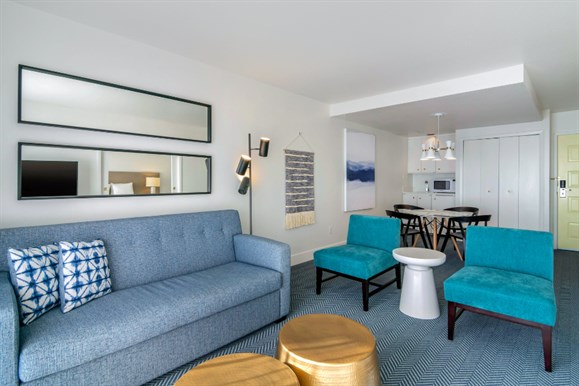 A couple lay on the bed in their comfortable embroidered Bayside waffle robes